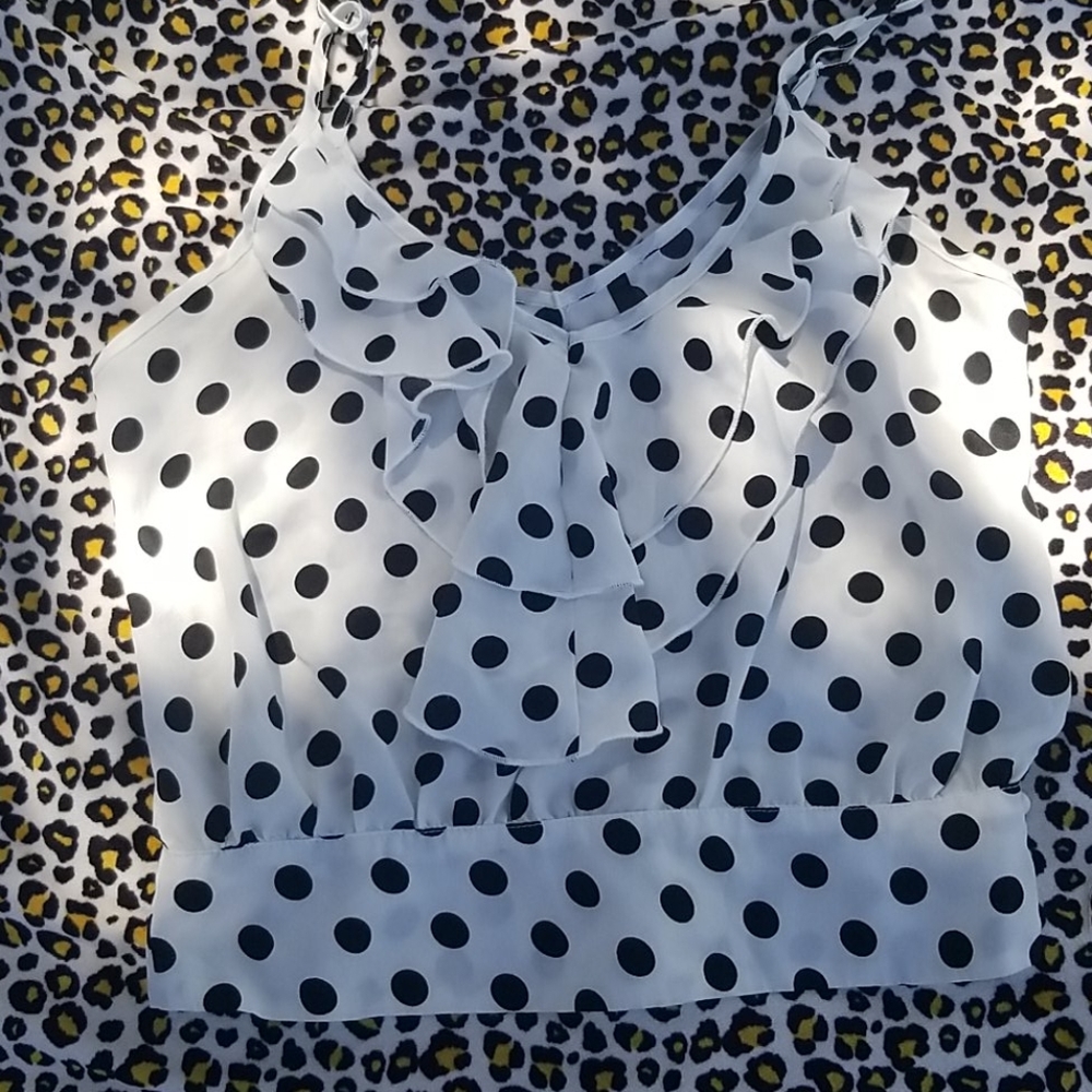 White with black polka dot sleeveless top.